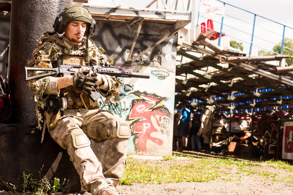 man-smoking-with-a-rifle-near-tree-2739446-1024x681